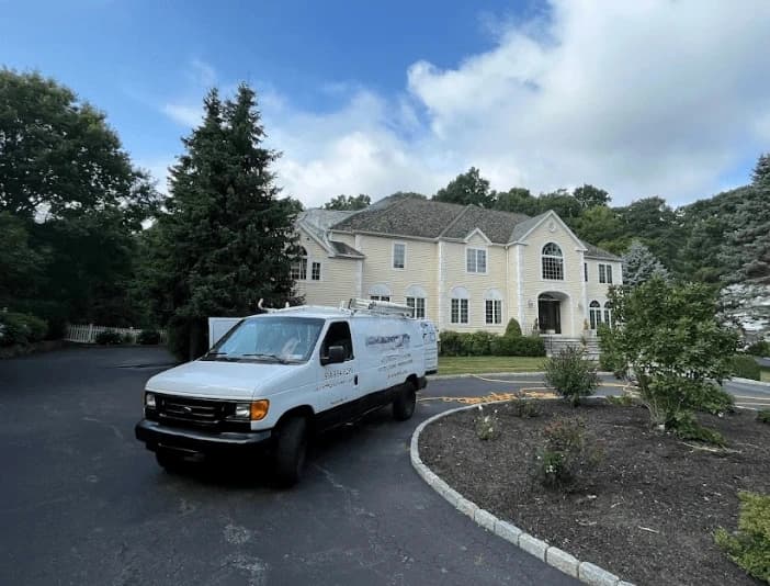 Medina Power Washing technician performing thorough gutter cleaning service in Medina